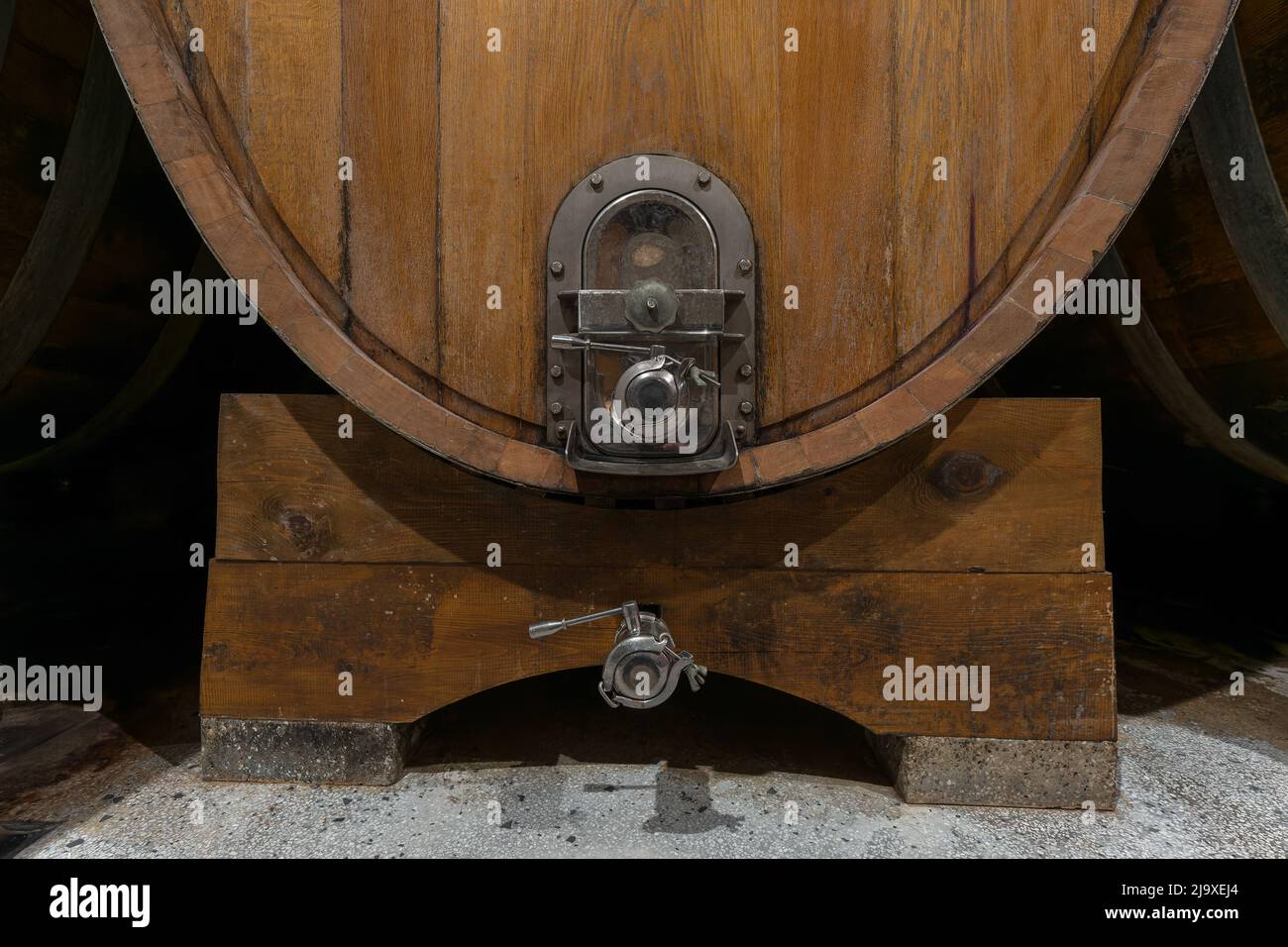 Interior of an authentic french wine cellar with old wooden barrels, aging of high quality wine, close-up shot. Stock Photo