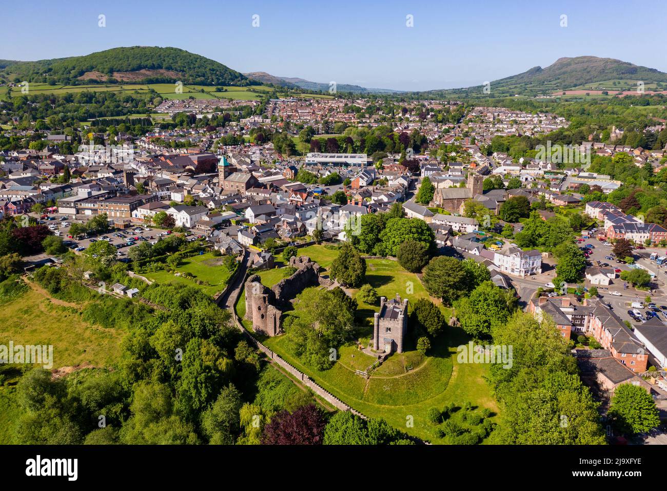 ABERGAVENNY, WALES - MAY 14 2022: Aerial view of the Welsh market town of Abergavenny, Monmouthshire surrounded by green fields and hills. Stock Photo