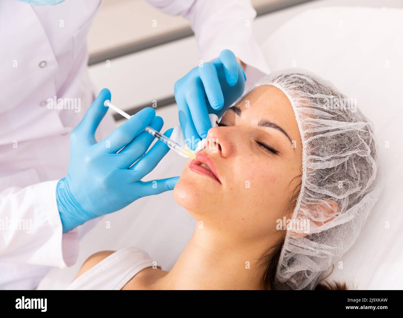Woman getting facial contouring injections Stock Photo Alamy
