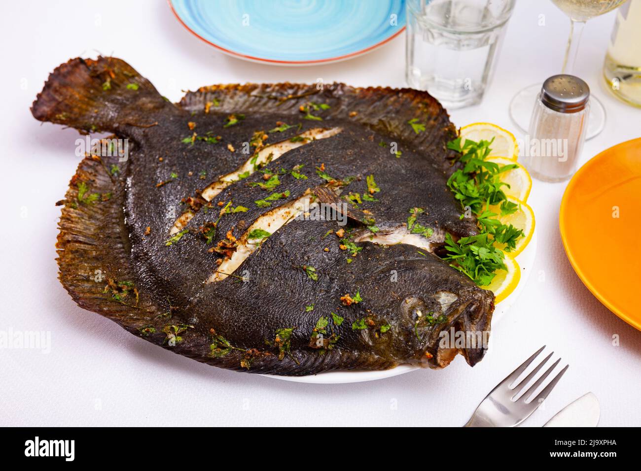 Baked flounder with parsley and lemon. Mediterranean cuisine closeup Stock Photo Alamy