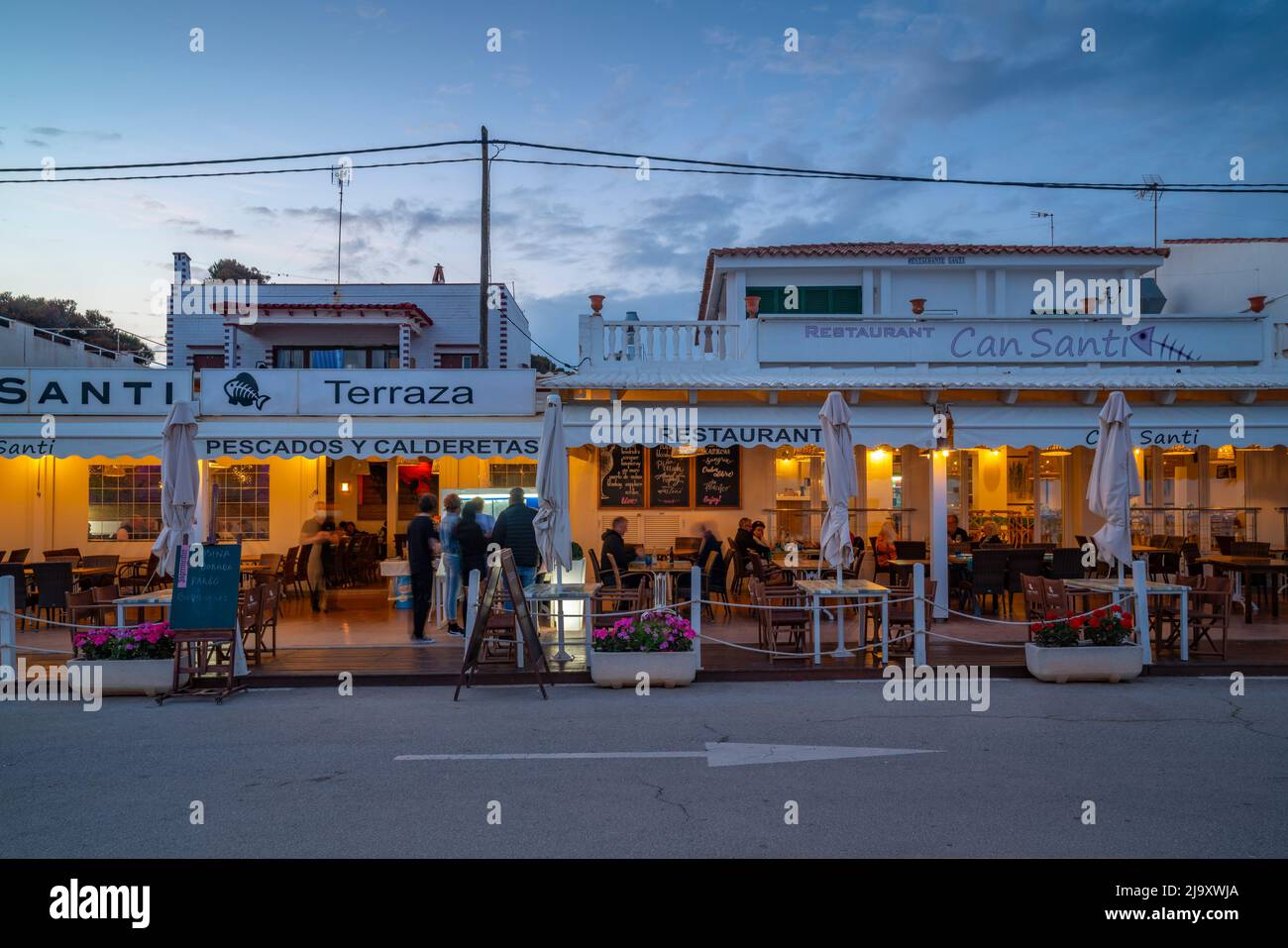 View of shops and bars overlooking Playa Punta Prima at dusk, Punta Prima,  Menorca, Balearic Islands, Spain, Europe Stock Photo - Alamy