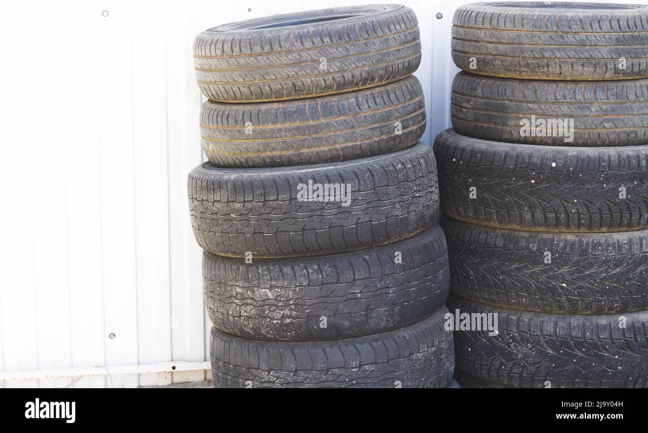 Changing car tires. Old rubber tires in the trash. Car dump. Garbage