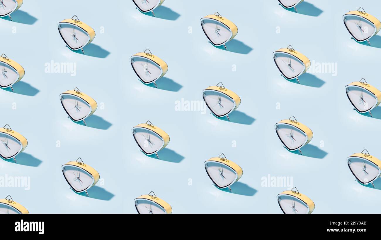 Many vintage alarm clocks pattern on blue background Stock Photo