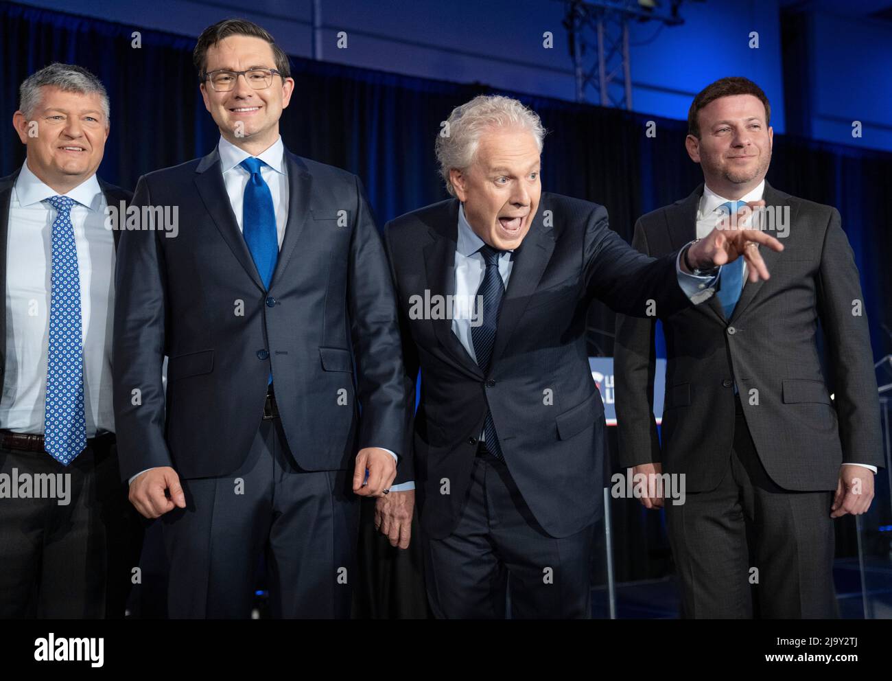 Candidates Scott Aitchison, left, Pierre Poilievre, Jean Charest and Roman  Baber, pose for photos after the