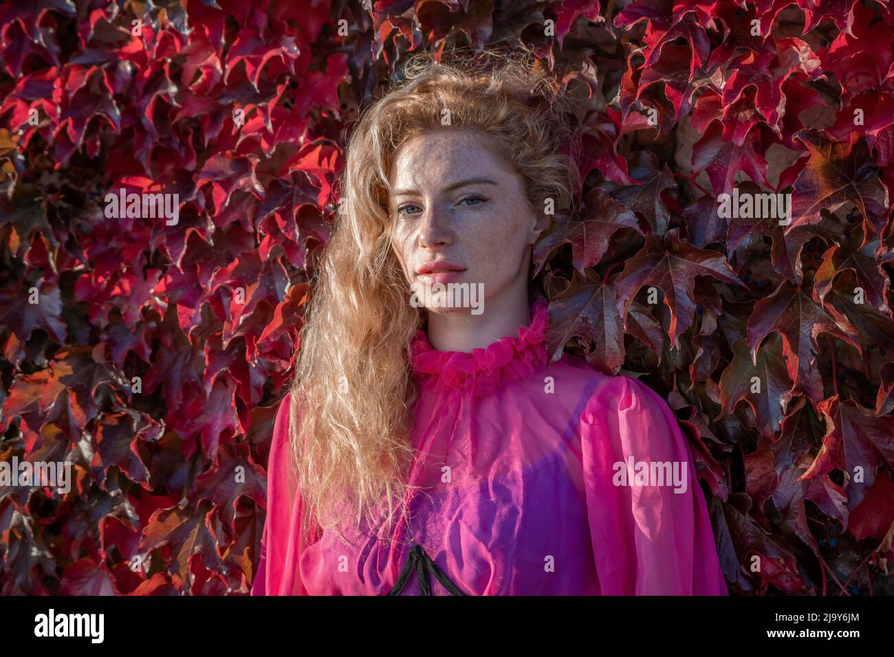 Close up shot of beautiful young caucasian woman with curly blond hair ...