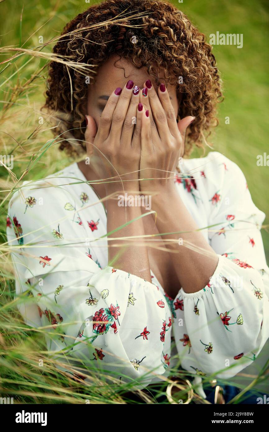 Black woman hiding face with hands crying Stock Photo