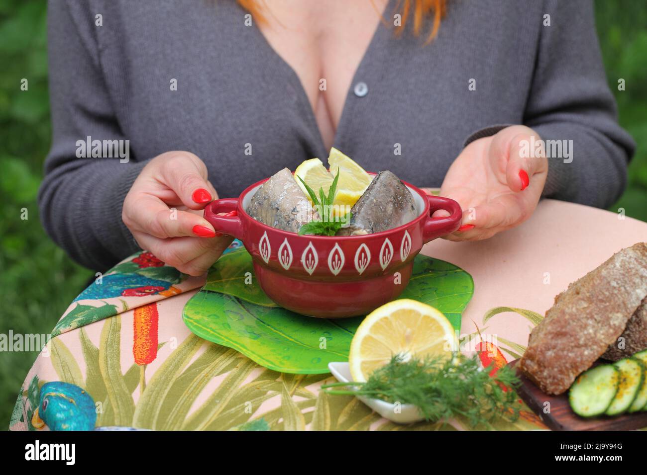 Woman eating canned mackerel Stock Photo Alamy