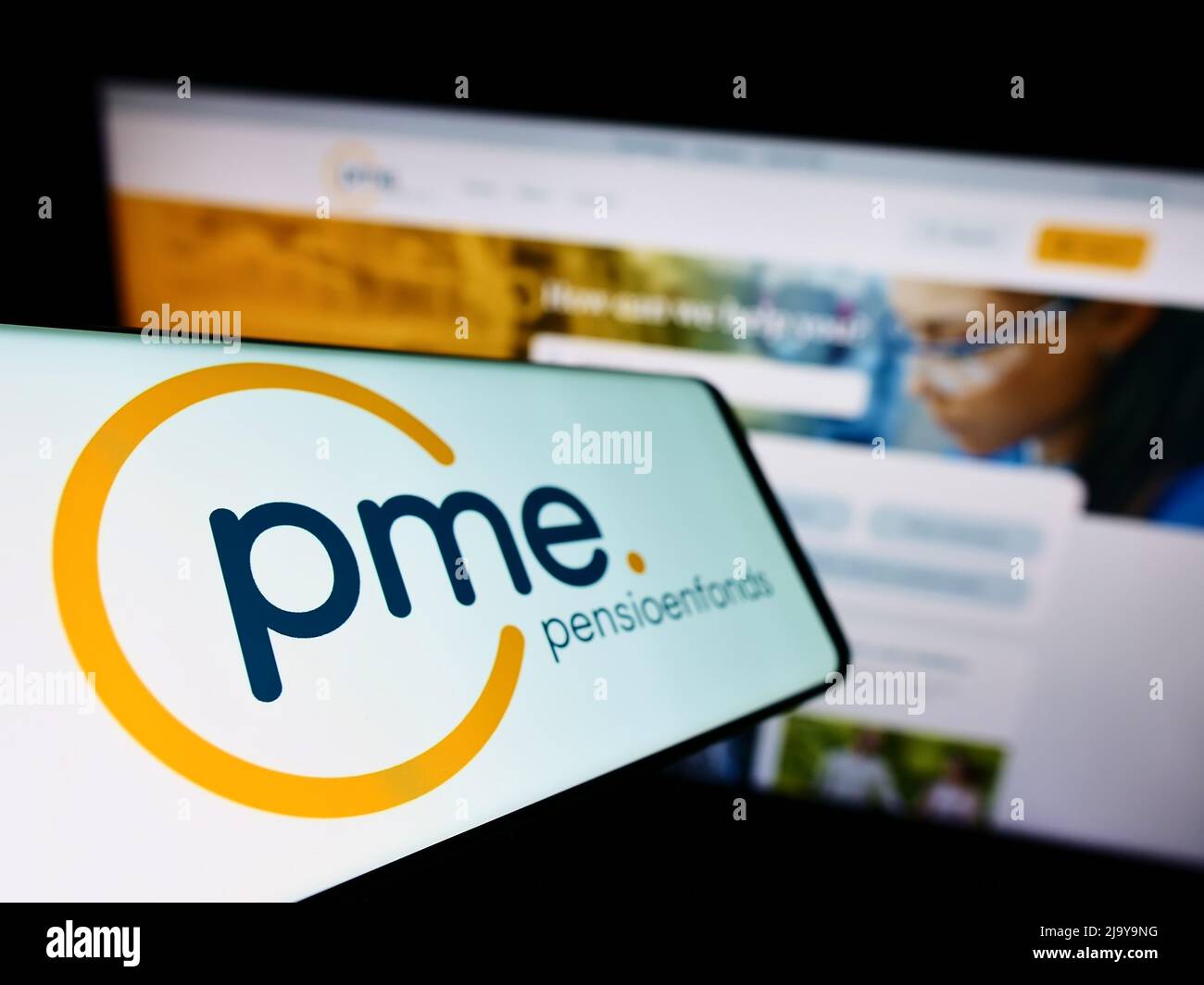Smartphone with logo of Dutch pension fund PME Pensioenfonds on screen in front of business website. Focus on left of phone display. Stock Photo