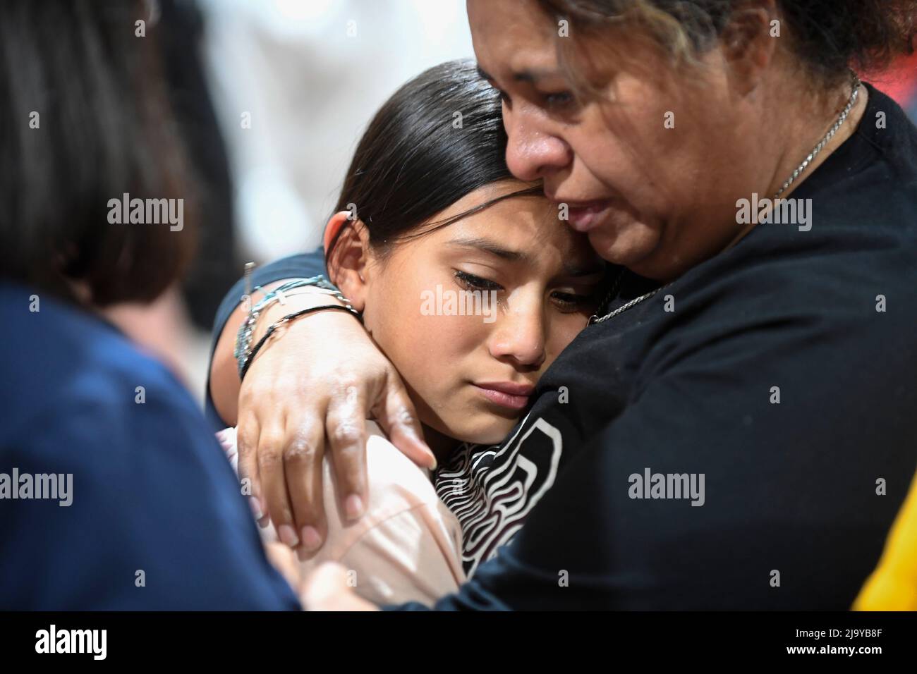 Uvalde, TX, USA. 25th May, 2022. A Uvalde fourth grade teacher who asked not to be identified hugs one of her students at a community healing service held at the Uvalde County fairgrounds on Wednesday, May 25, 2022. The event follows a mass shooting at Uvalde's Robb Elementary School that killed 19 students and two teachers on Tuesday. (Credit Image: © Bob Daemmrich/ZUMA Press Wire) Stock Photo
