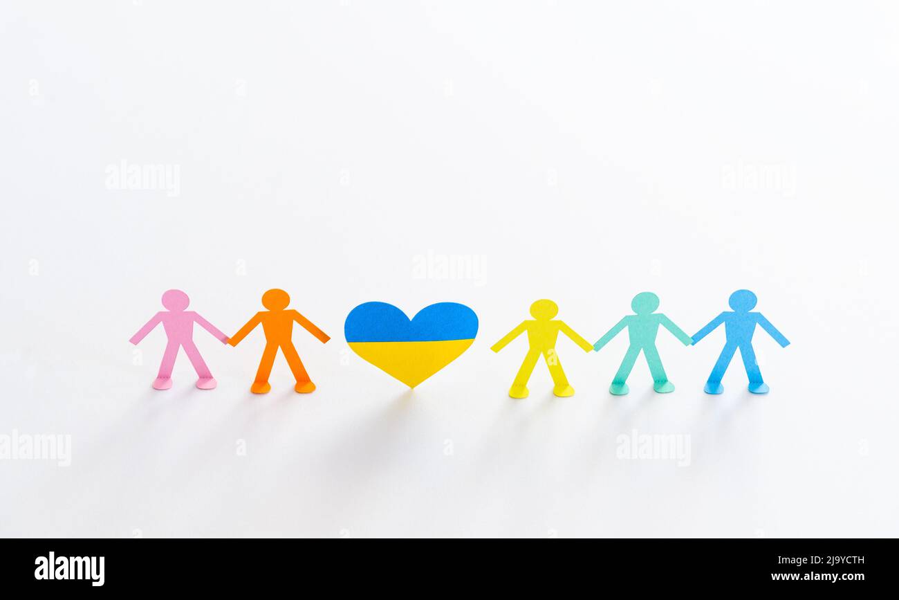 heart in colors of ukrainian flag and people chain, concept of help and support for ukraine Stock Photo