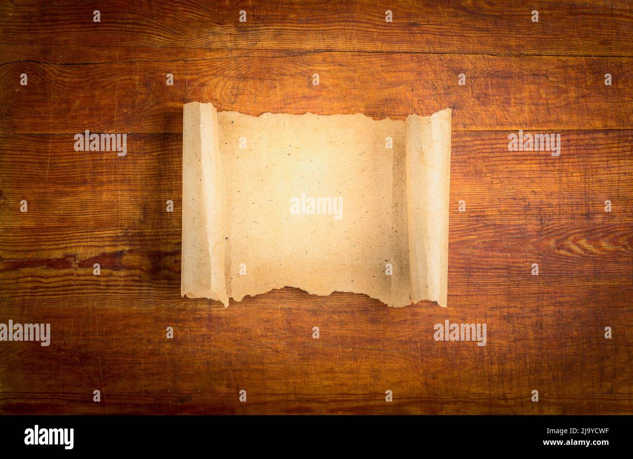 parchment scroll on wooden background. Stock Photo