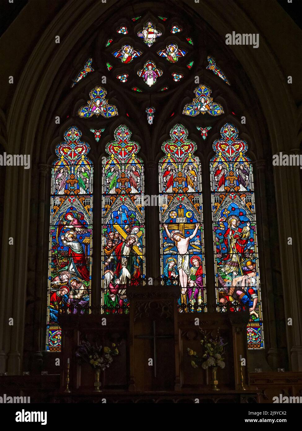 St John the Evangelist church in Otterburn, Northumberland, UK with stained glass window