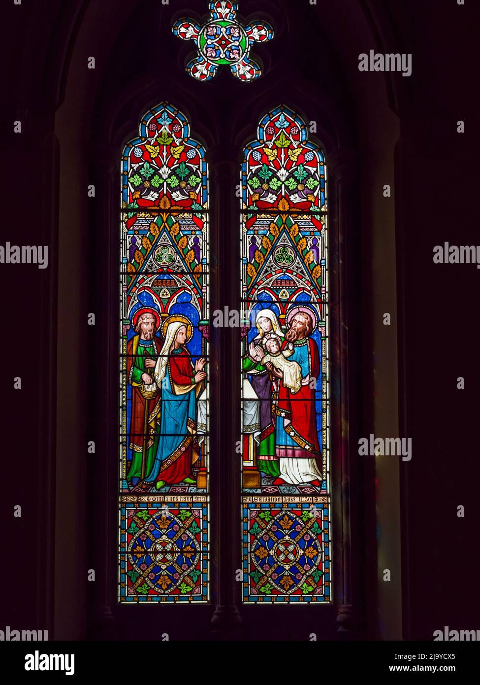 St John the Evangelist church in Otterburn, Northumberland, UK with stained glass windows. Stock Photo