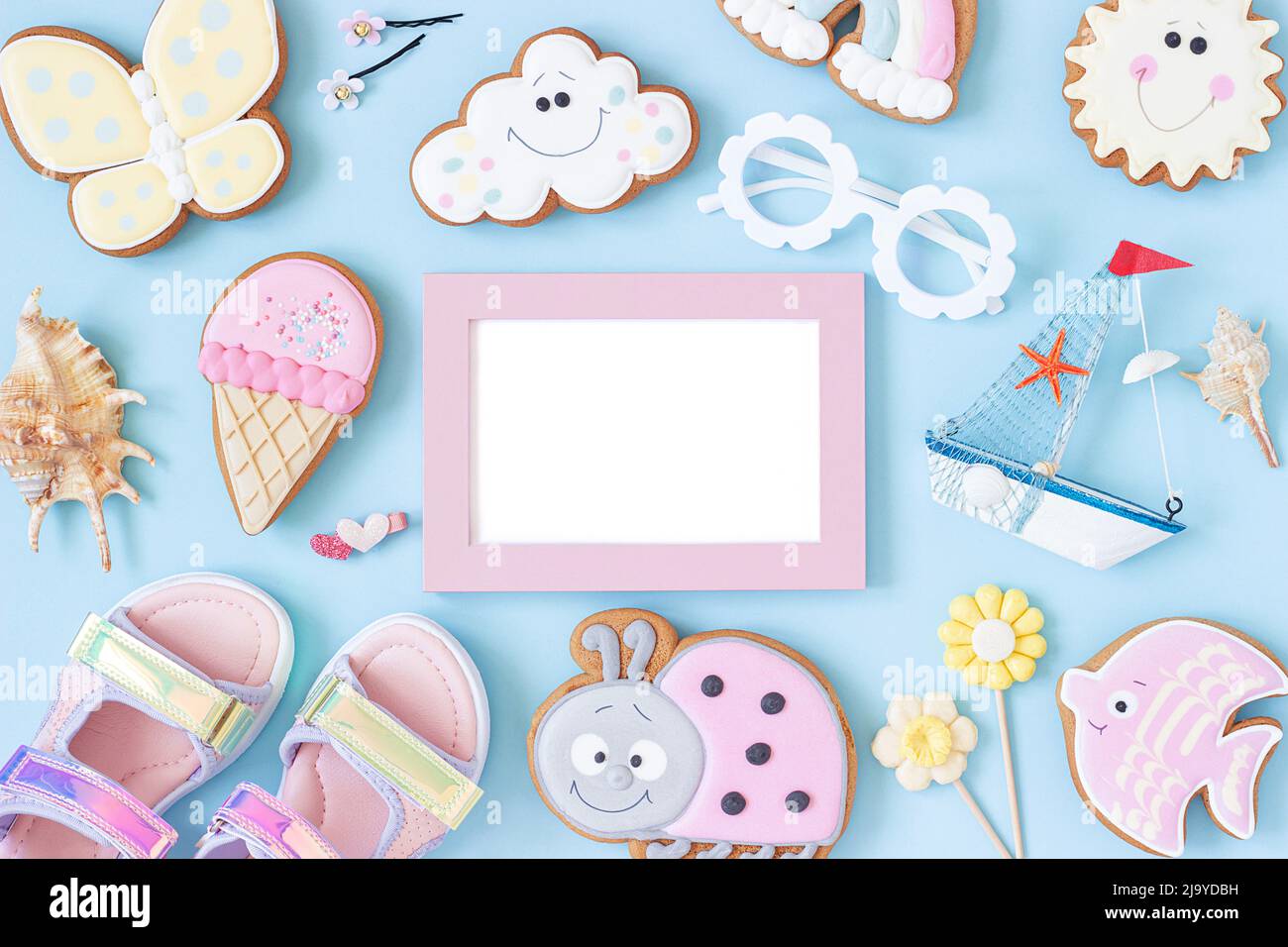 Bright creative layout made of white blank frame and cute summer symbols on pink background. Copy space, Top view, Flat lay. Mock up. Creative summer Stock Photo