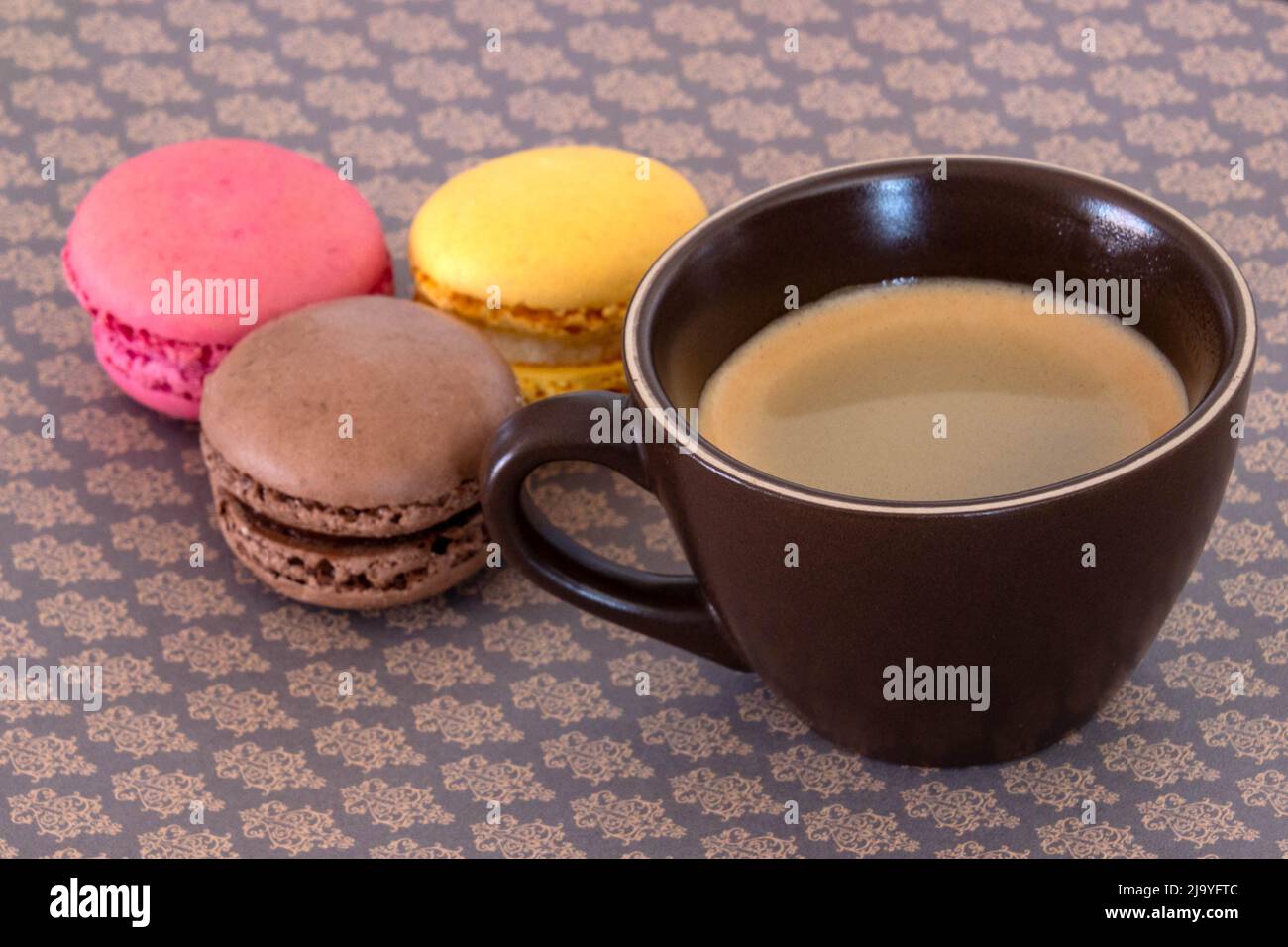 cup of coffee with macaroons on a table Stock Photo