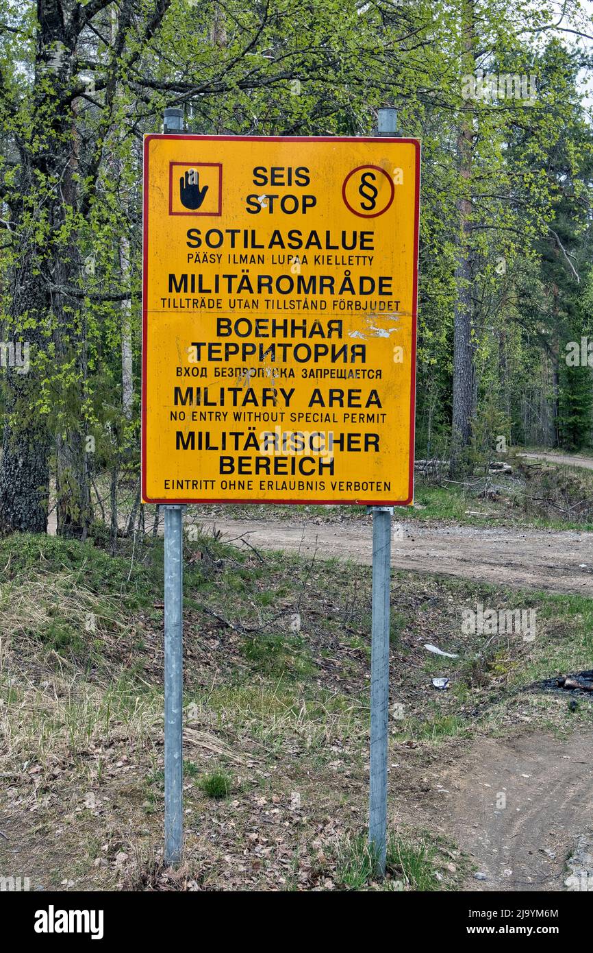 Military area keep out sign in Finnish, Swedish, Russian, English and German texts, Finland Stock Photo