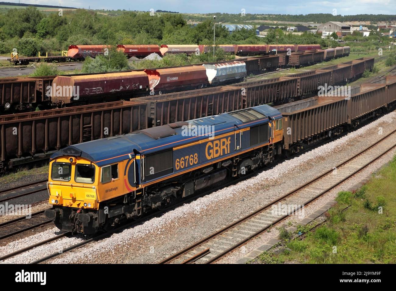 GB Railfreight Class 66 loco 66768 hauls the 6D21 1402 Roxby Gullet (nr Scunthorpe) to Doncaster empty stock service through Scunthorpe on 24/5/22. Stock Photo