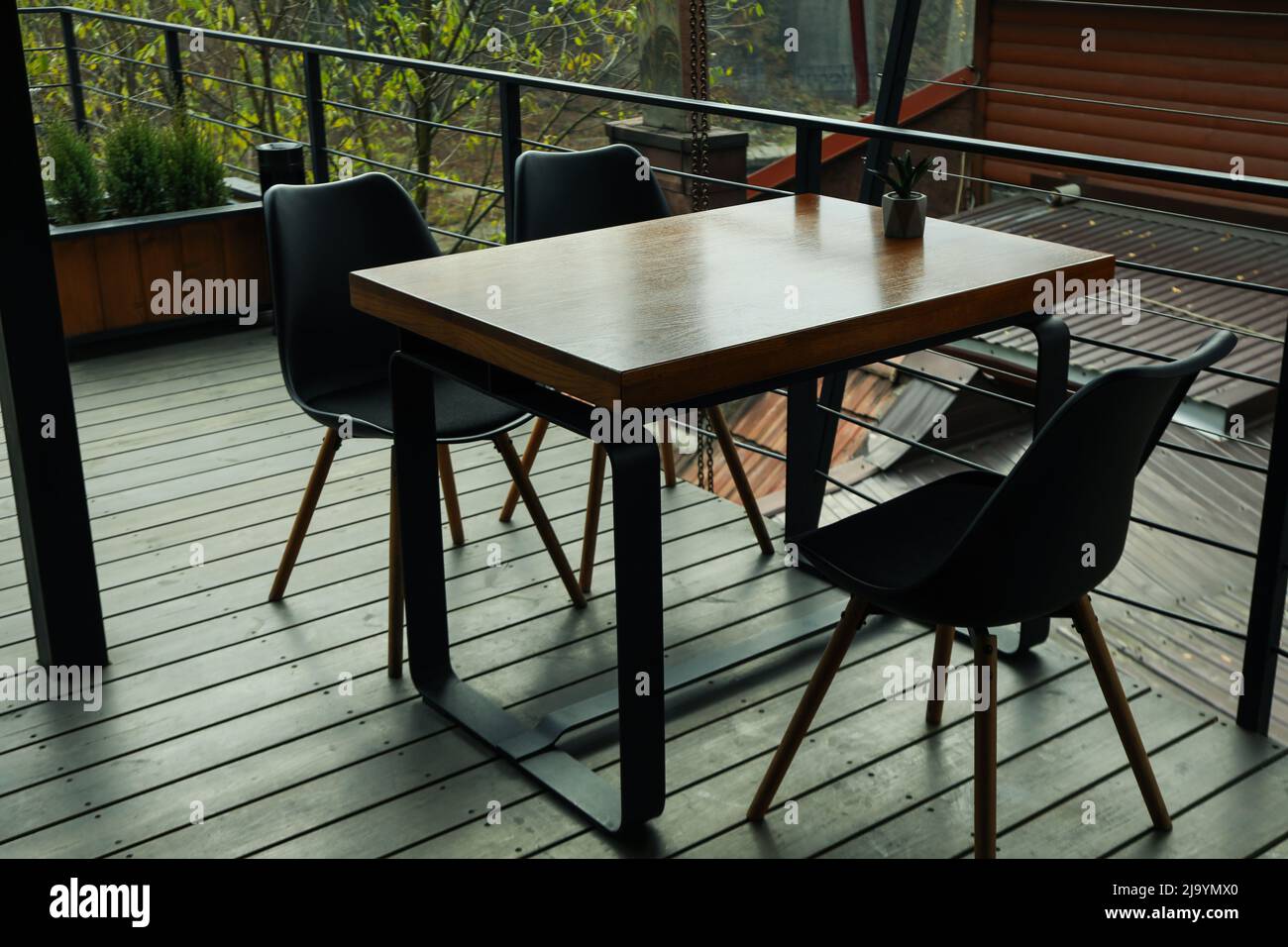 Table with chairs in stylish wooden restaurant Stock Photo