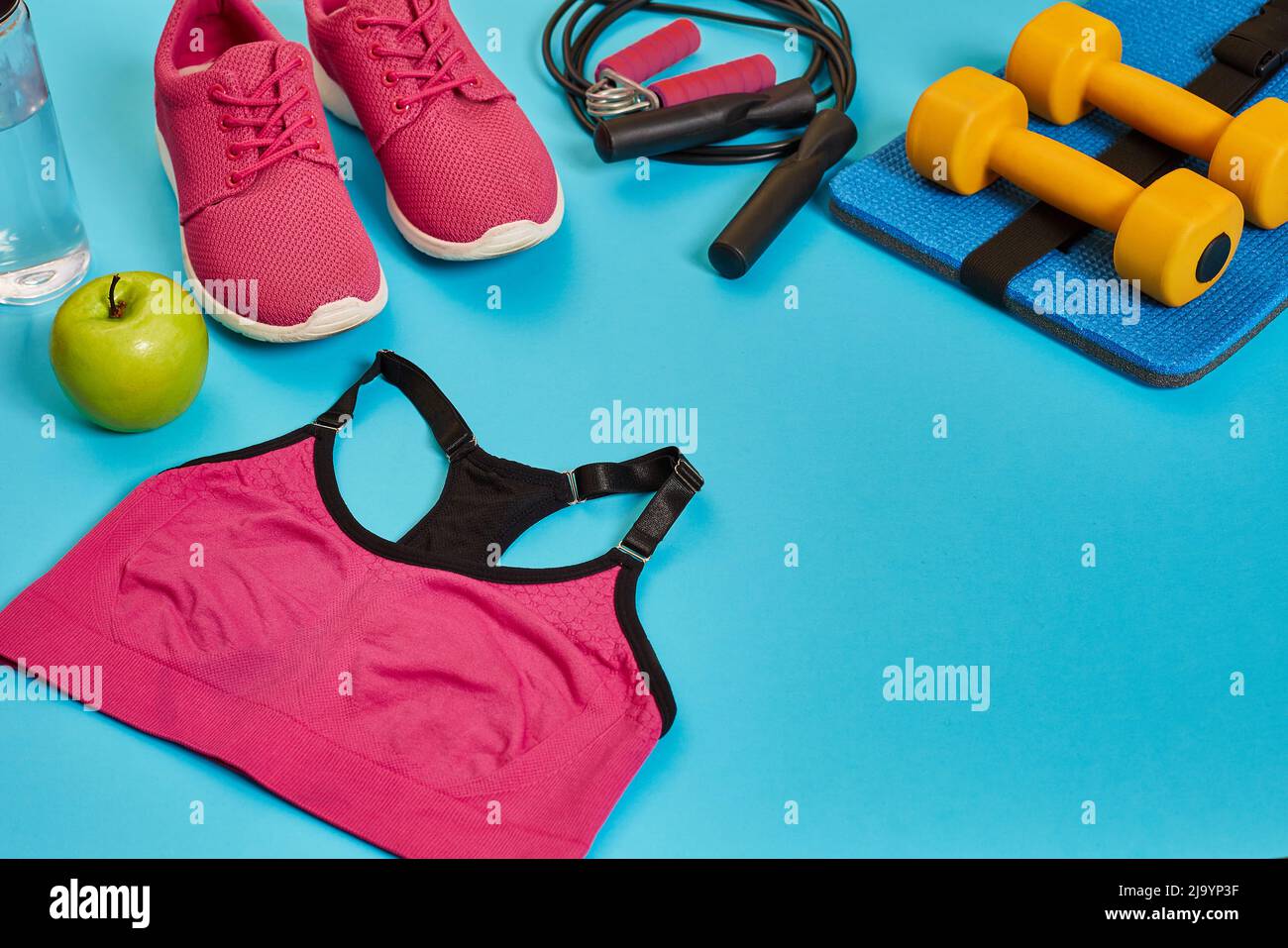 Flat lay of dumbbell, bottle of water, jump rope and sneaker, sport ...