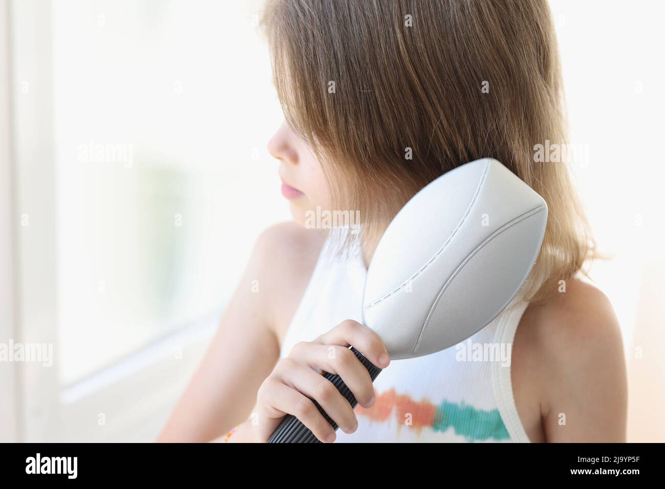 Little beautiful baby girl combs hair closeup Stock Photo Alamy