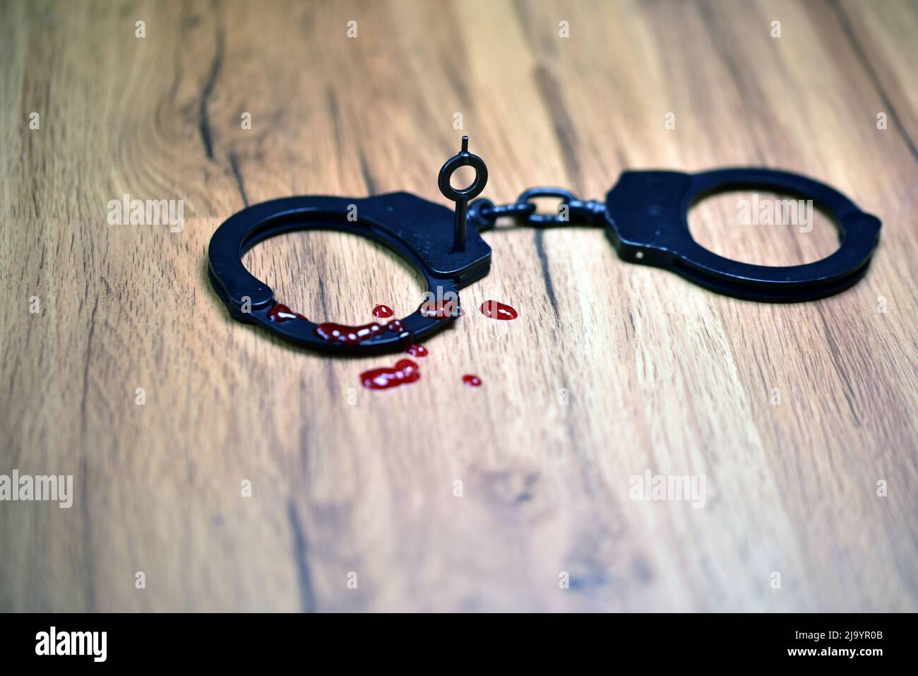 black metal handcuffs with blood Stock Photo