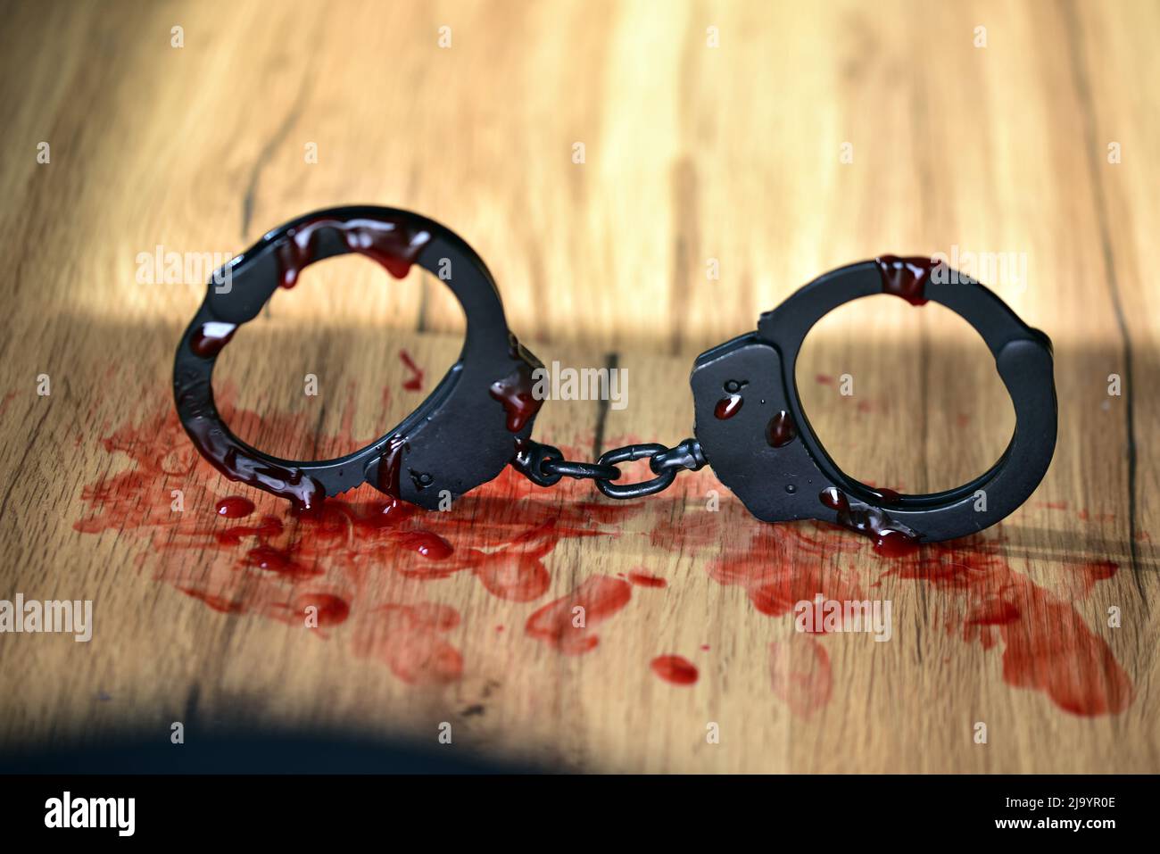 black metal handcuffs with blood Stock Photo