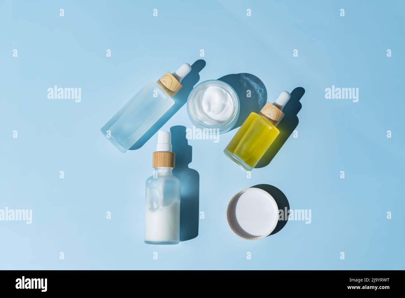 Set of frosted glass cosmetic bottles on blue background. dropper bottles  and cream jar package. Skincare beauty products packaging design fro daily  r Stock Photo - Alamy