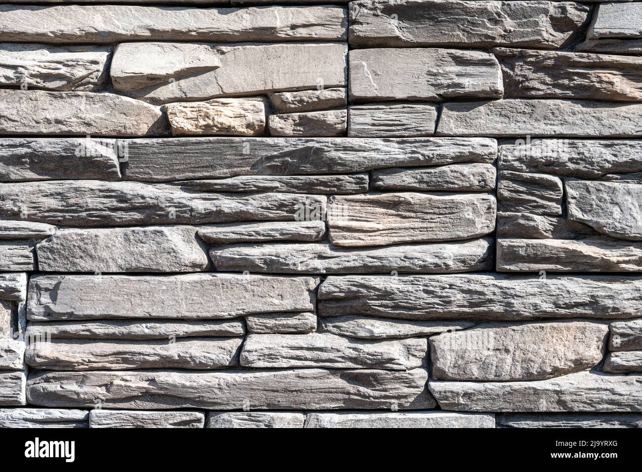 Background from a wall made of old natural gray stone Stock Photo