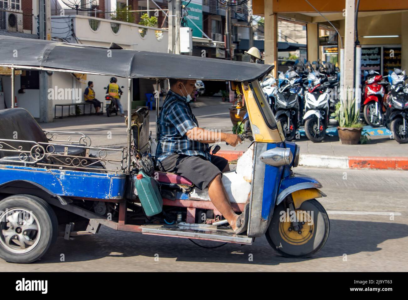 SAMUT PRAKAN, THAILAND, APR 06 2022, A traditional taxi tricycle Tuk Tuk rides in the streets of Bangkok. Stock Photo