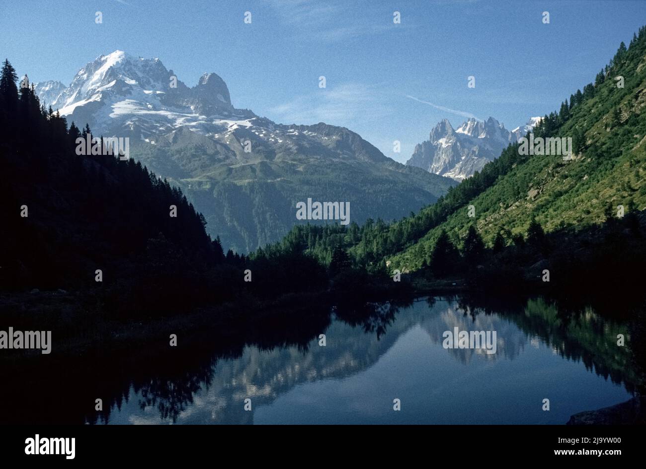 At the Col des Montets. The surrounding mountains are reflected in a mountain lake. Chamonix Mont Blanc, Haute Savoie, France, 1990 Stock Photo