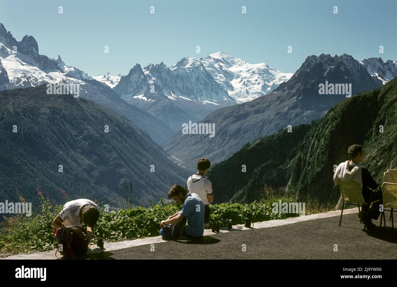 From the Lac d'Emosson dam, tourists view the Mont-Blanc massif with Mont Blanc and the Aiguilles de Chamonix, Valais, Switzerland, 1984 Stock Photo