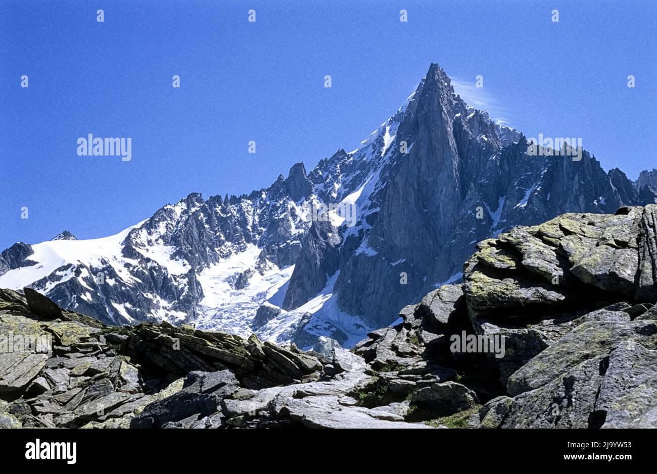 Aiguilles du Drus from the hiking trail from Plan d'Aiguille to Montenvers. There is a small veil of cloud around the peaks. Chamonix, France, 1990 Stock Photo