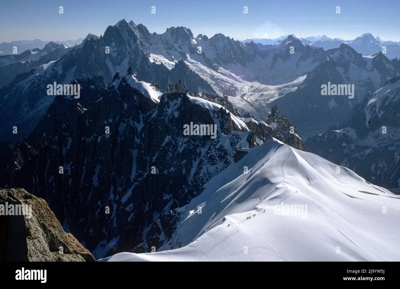 Aiguilles de Chamonix and Glacier de Talèfre with climbers on the snow ridge seen from the Aiguille du Midi, Chamonix-Mont-Blanc, France, 1990 Stock Photo