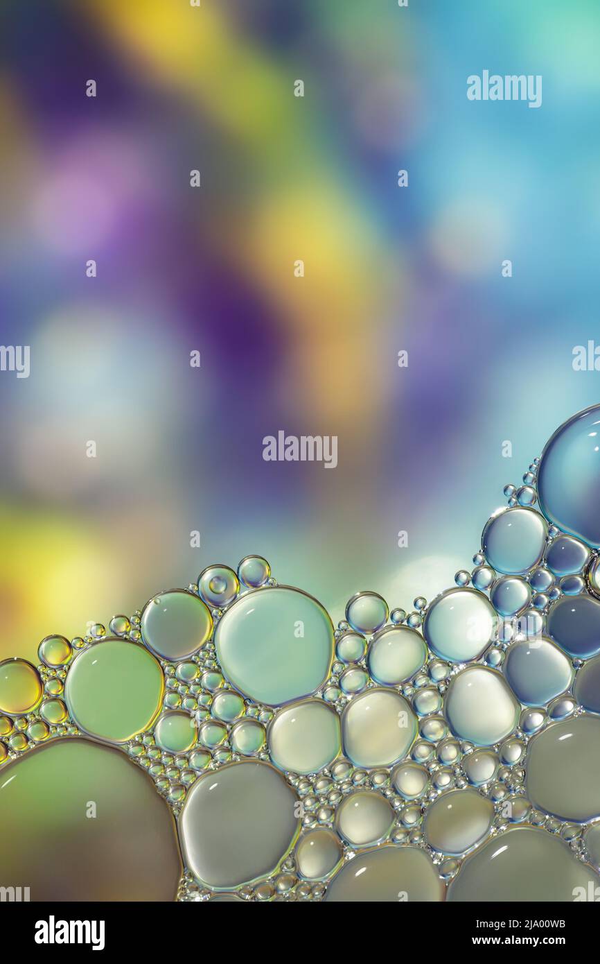 Fantasy colorful blurry background with ornament made of soft clear bubbles, abstract color splashes with copy space, focus on foreground Stock Photo