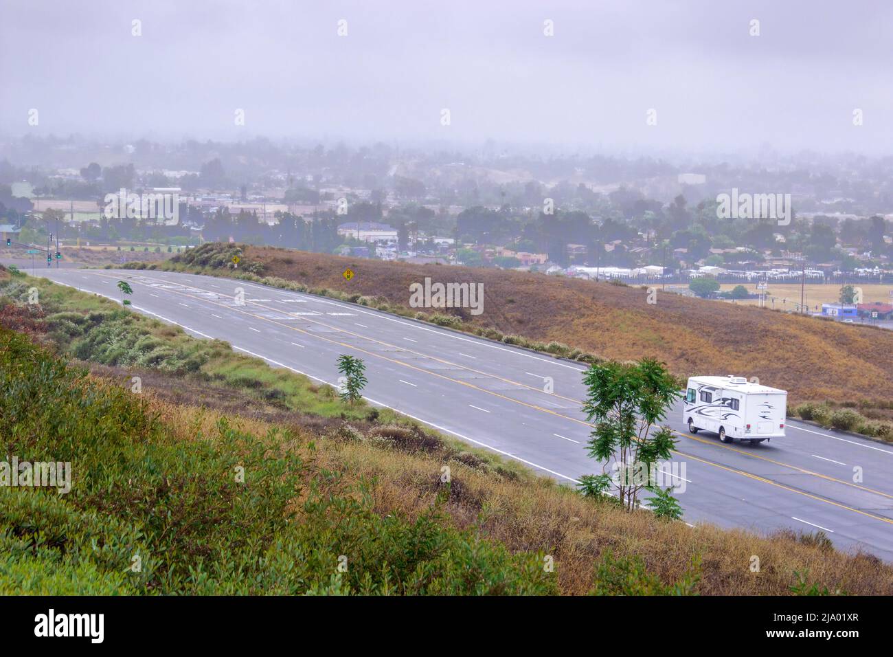 A Winnebago Vista Motor Home on an empty road in the hills above Yucaipa, California USA Stock Photo