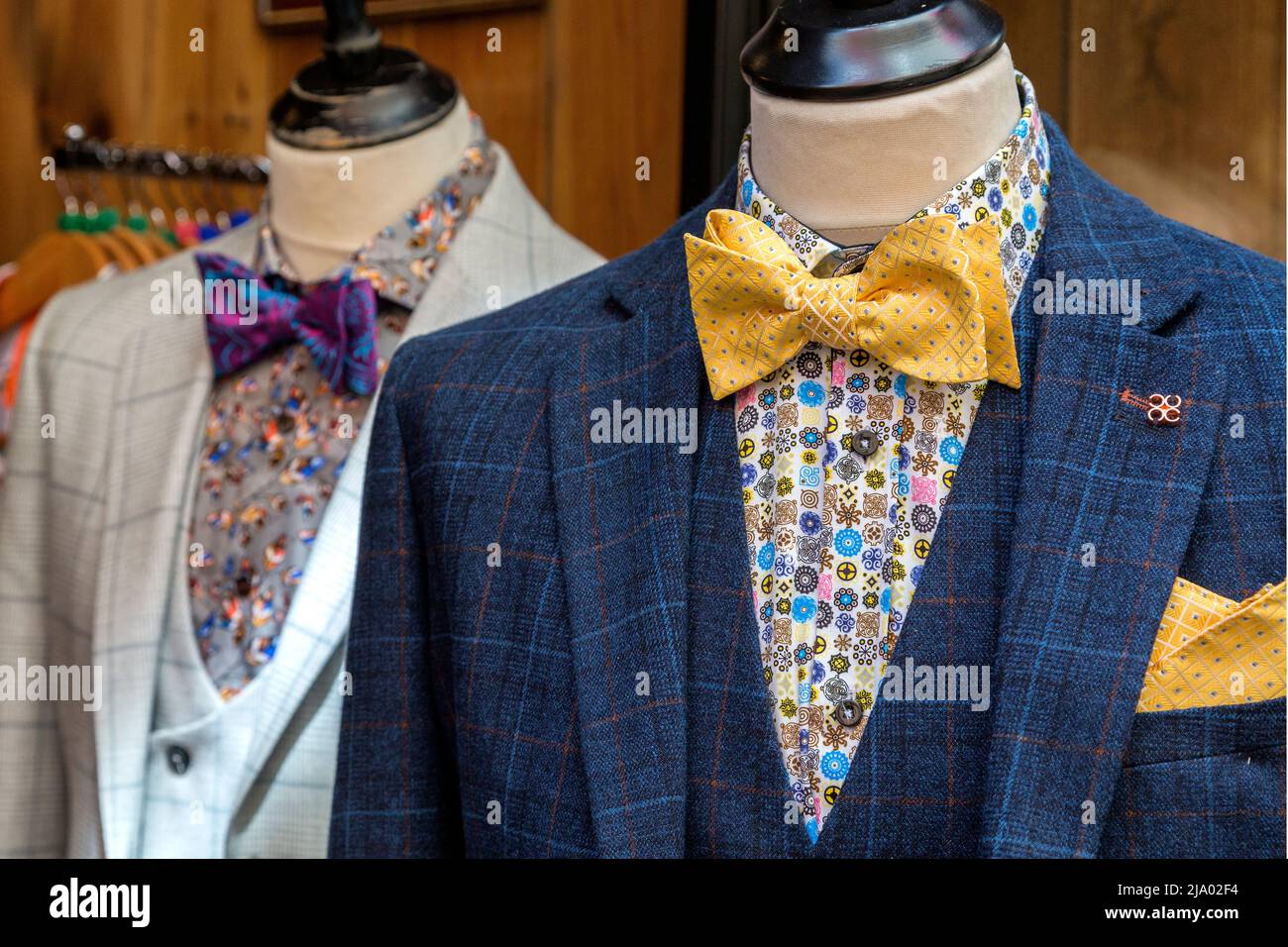 Very smart men's suits for sale in a high street shop. Concept of fashion industry, retail or high street spend. Stock Photo