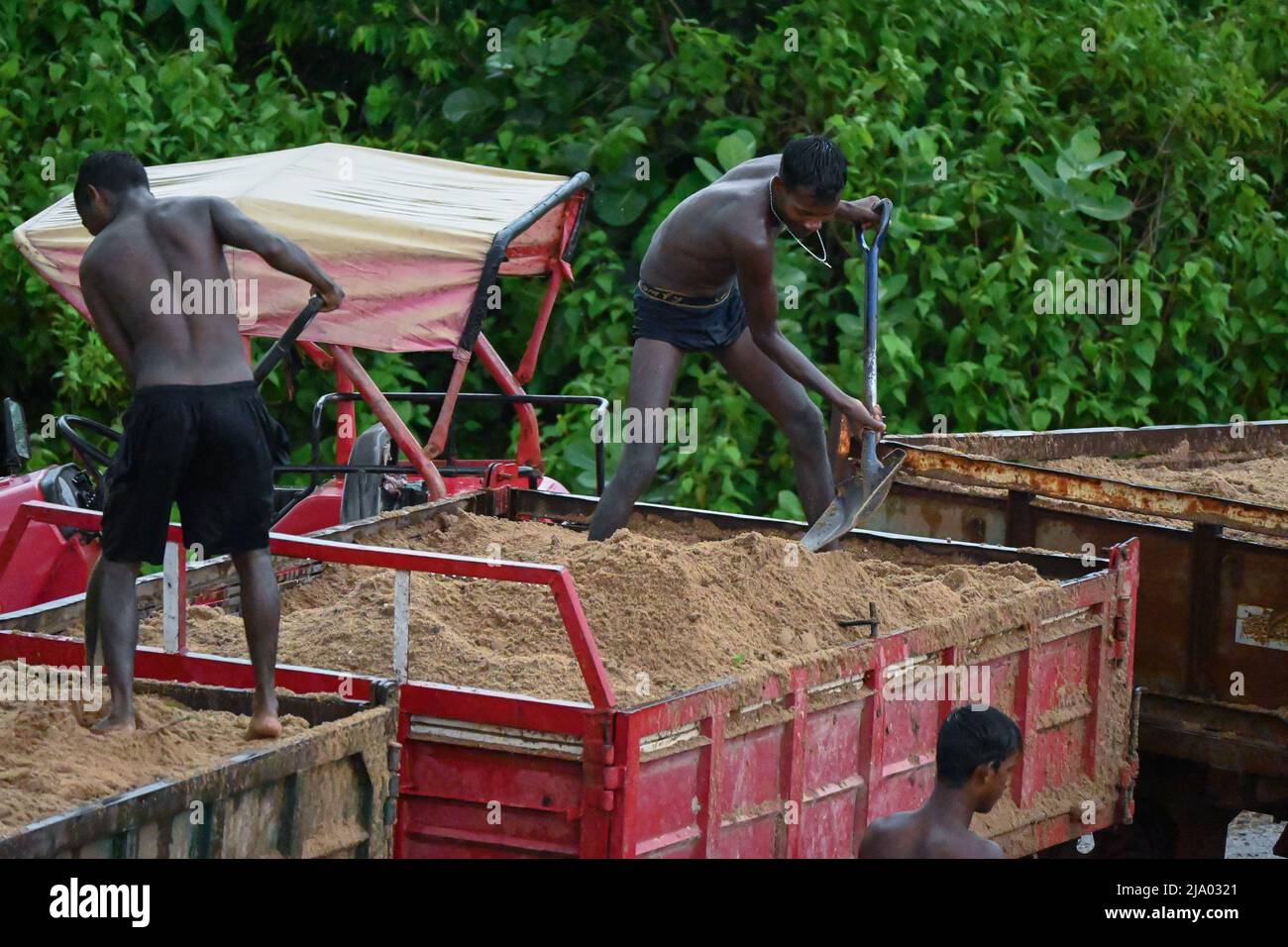 river sand loading by people Stock Photo