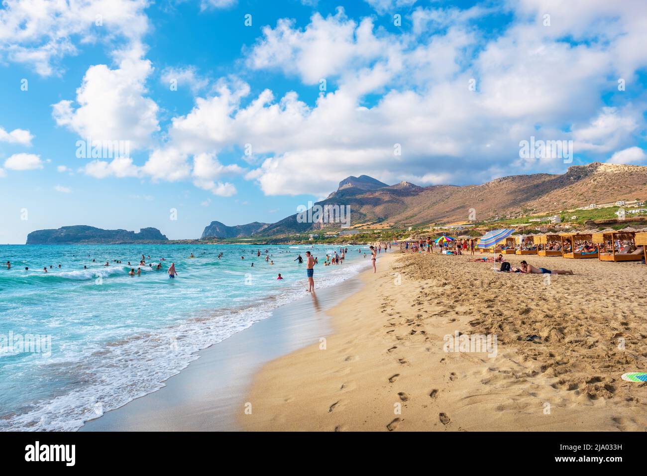 Tourists enjoy relaxing on a picturesque beach in Falassarna. Crete, Greece Stock Photo