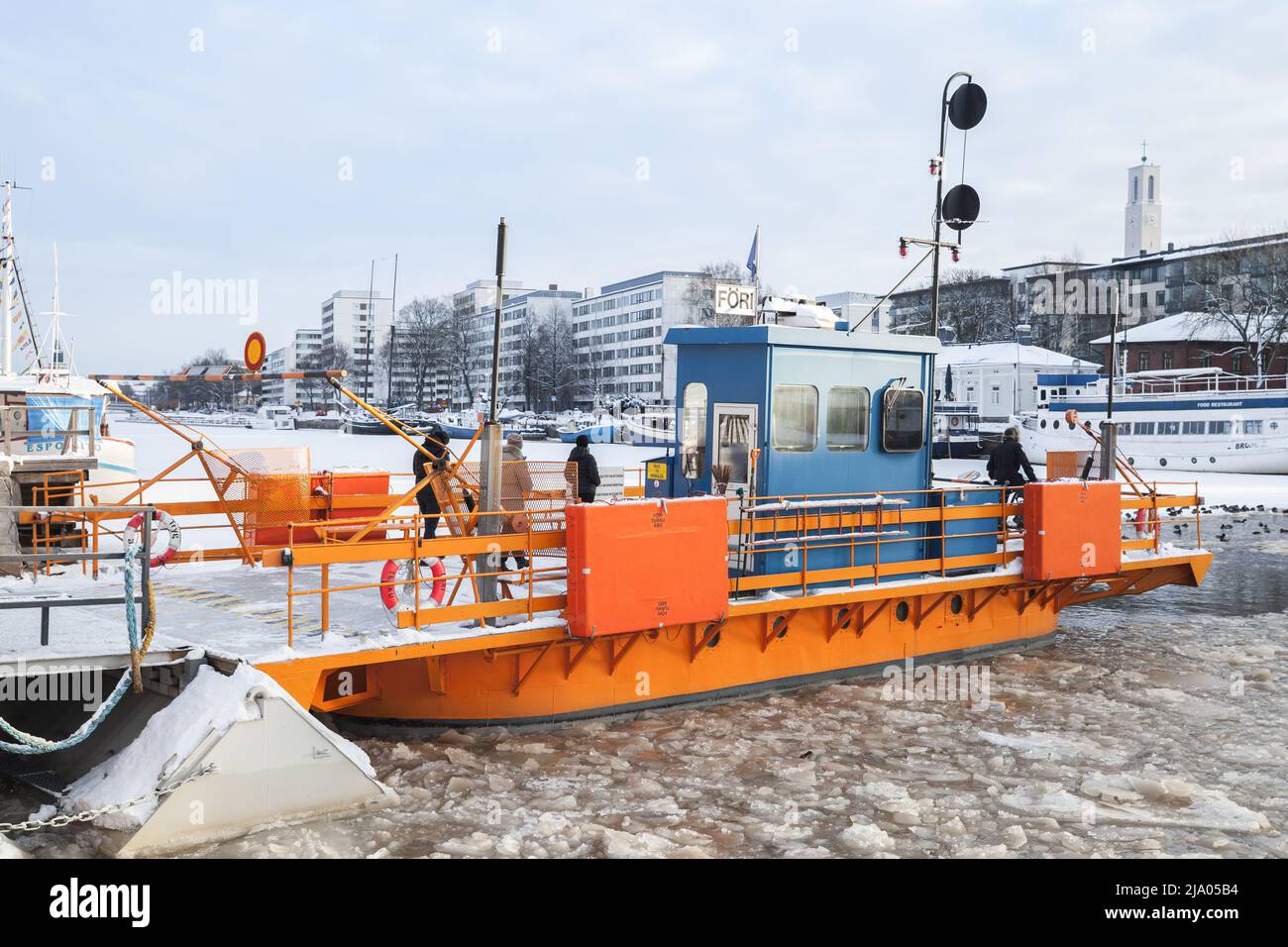 Turku, Finland - January 22, 2016: Passengers are on small city boat Fori, this is a light traffic ferry that has served the Aura River for over a hun Stock Photo
