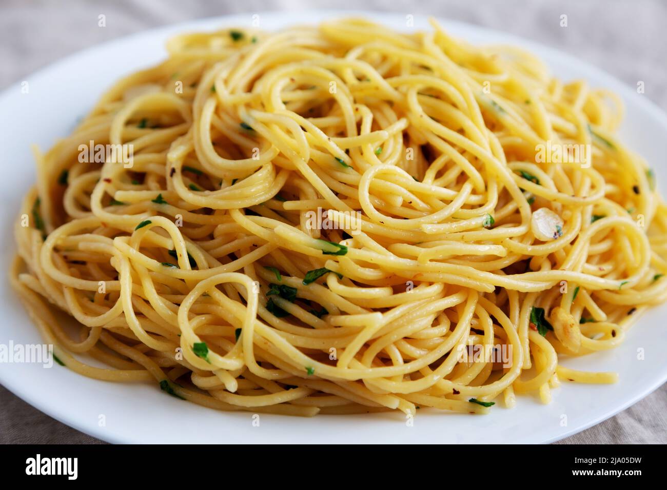Homemade Spaghetti with Garlic and Oil Pasta on a Plate, side view