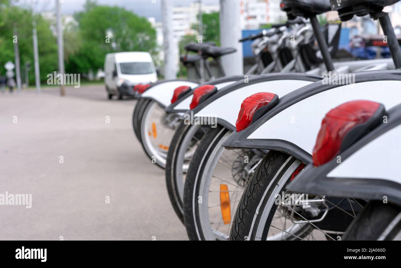 Red tail lights on rental bikes. Row of bicycles on the bike parking