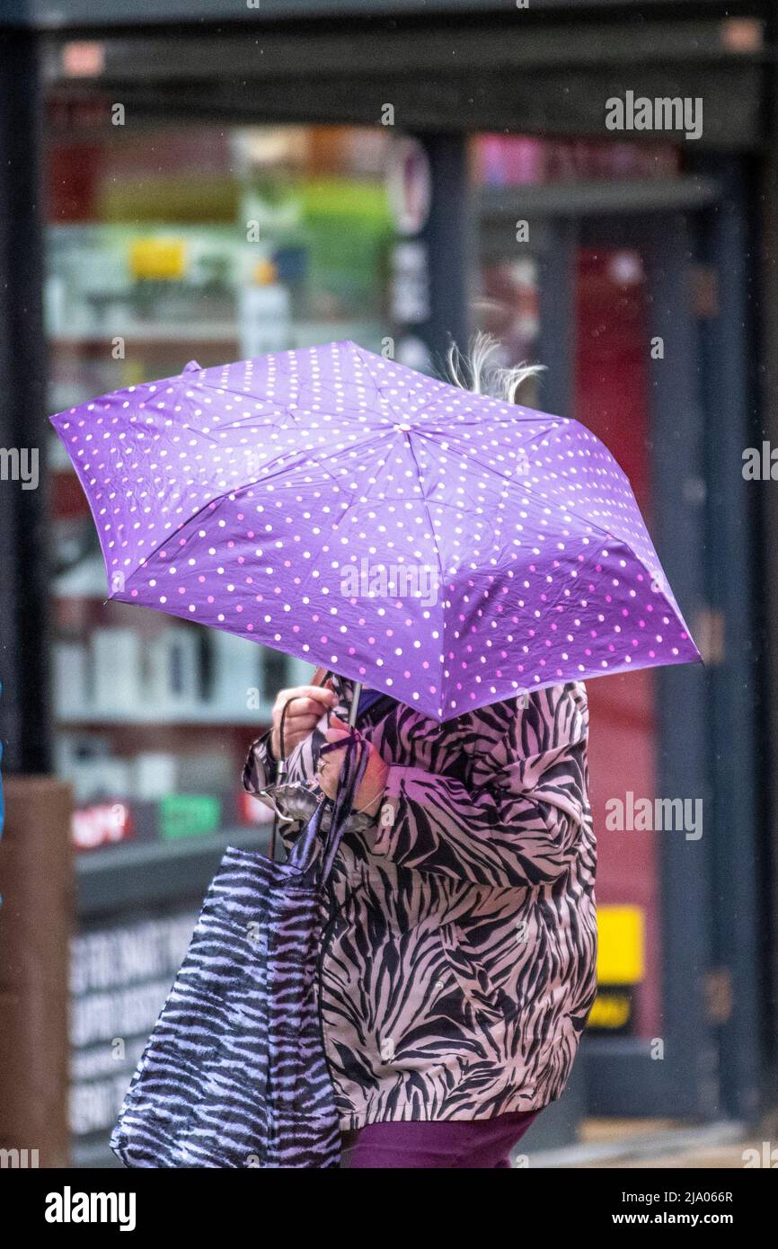 Preston, Lancashire.  UK Weather 26 May 2022.  No signs of summer as yet another rainy start to the day for shops, shoppers and shopping in Preston. A dull and wet start to today, with spells of rain moving in.  Credit. MediaWorldImages/AlamyLiveNews Stock Photo