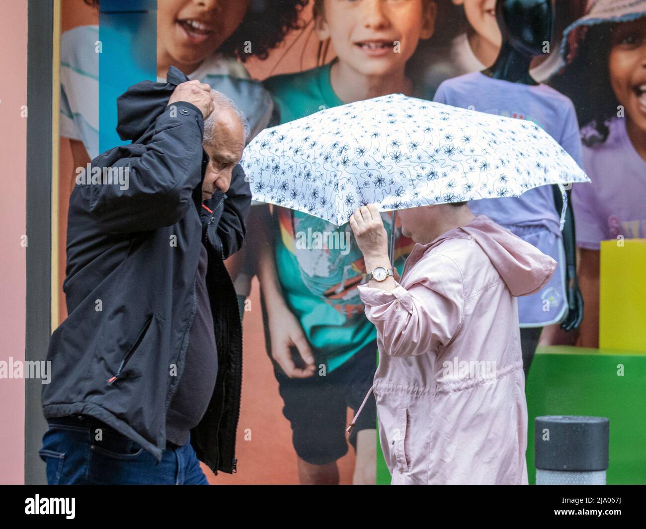 Preston, Lancashire.  UK Weather 26 May 2022.  No signs of summer as yet another rainy start to the day for shops, shoppers and shopping in Preston. A dull and wet start to today, with spells of rain moving in.  Credit. MediaWorldImages/AlamyLiveNews Stock Photo