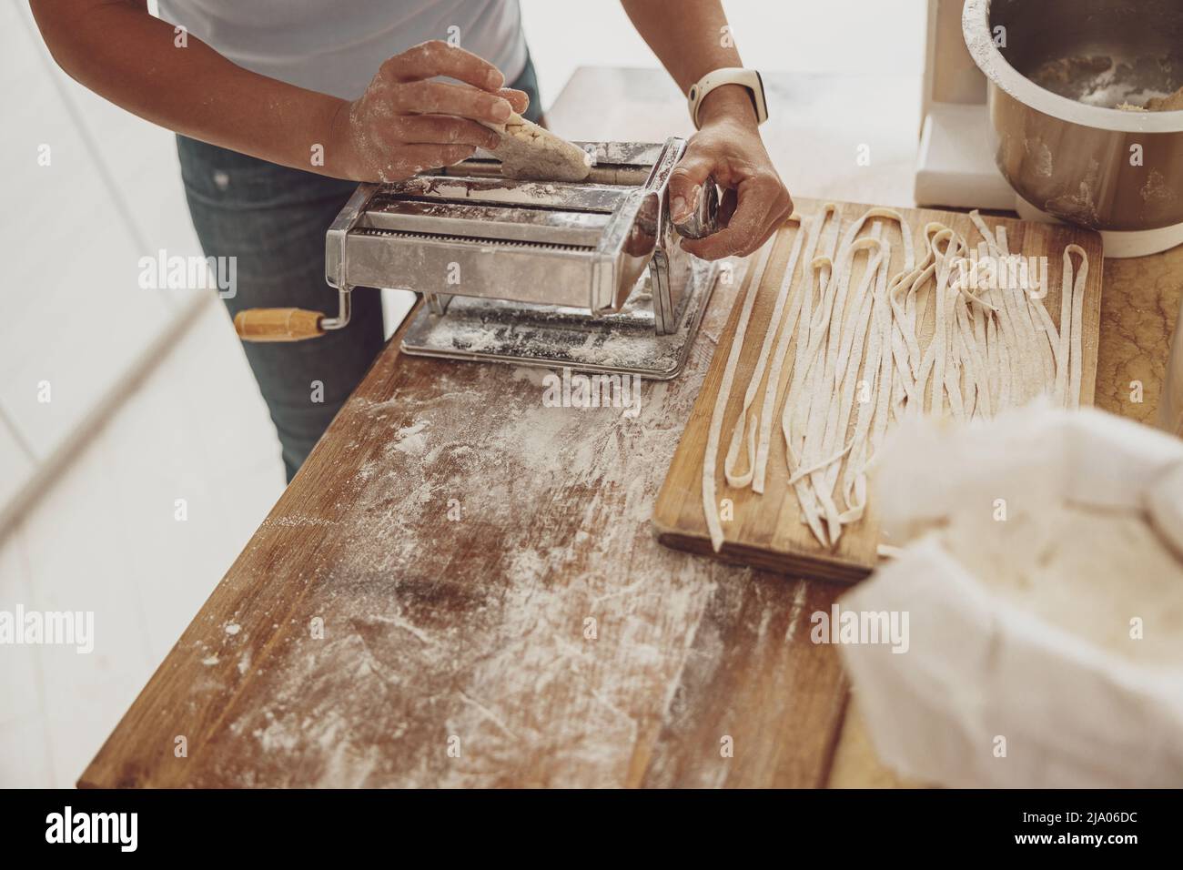 Cooking homemade noodles by a woman with a noodle cutter in the