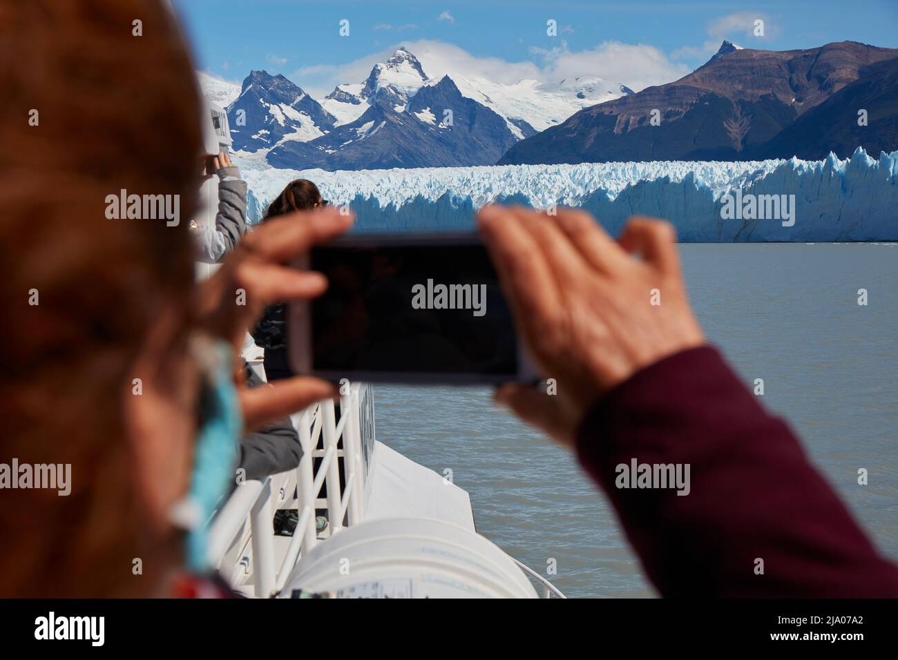 A tourist photographing the Perito Moreno glacier with a smartphone, El Calafate, Santa Cruz, Argentina. Stock Photo