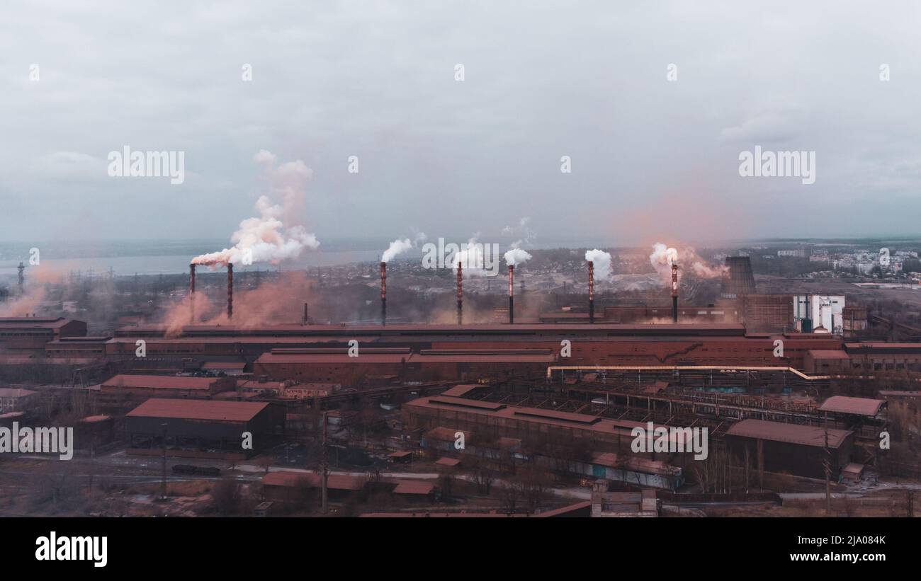 A chimney chemical plant in the discharge of pollutants, Industry Pipes Pollute the Atmosphere With Smoke Stock Photo