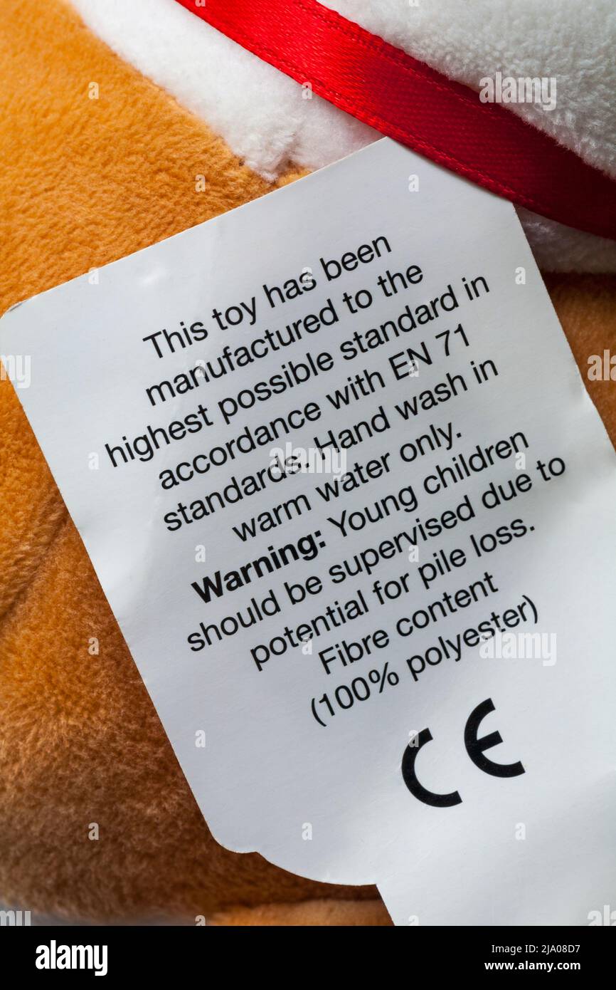 label on child's soft toy with washing instructions and warning with CE mark symbol Stock Photo