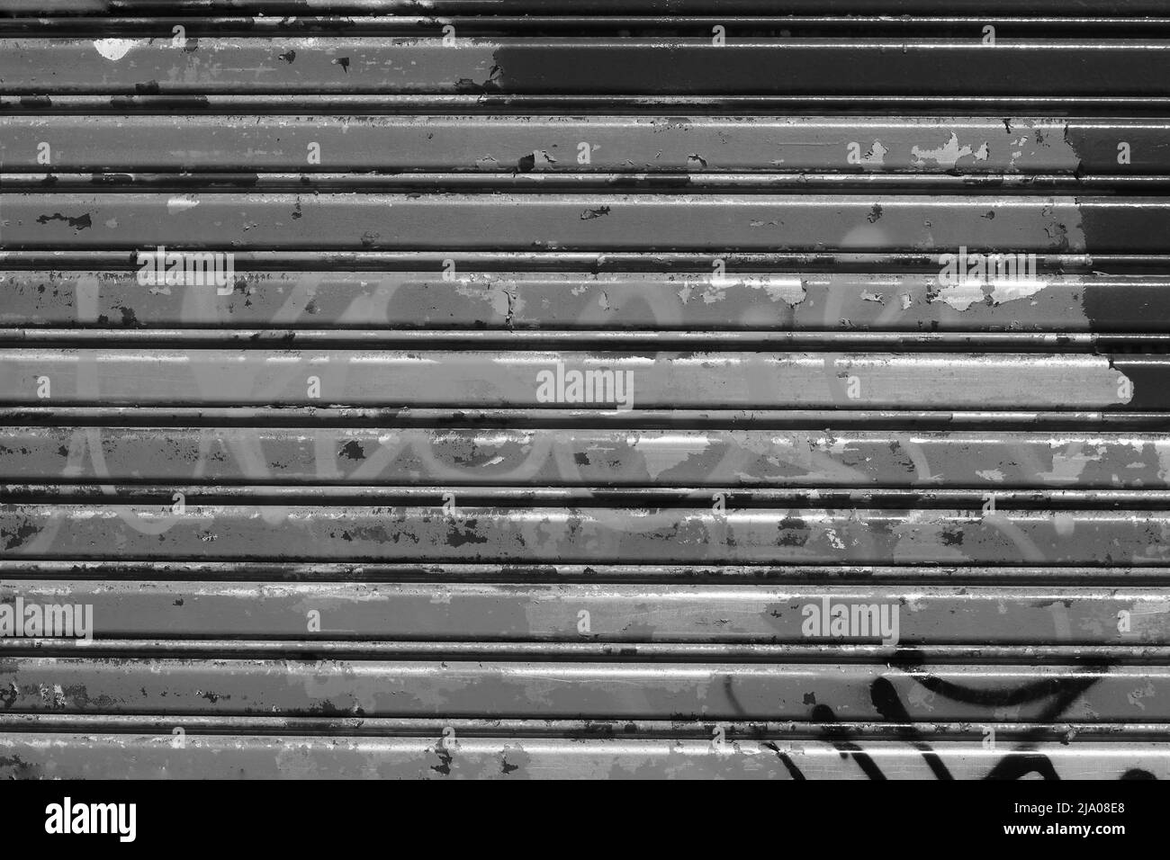 Metal warehouse garage door with horizontal lines in black and white. Stock Photo