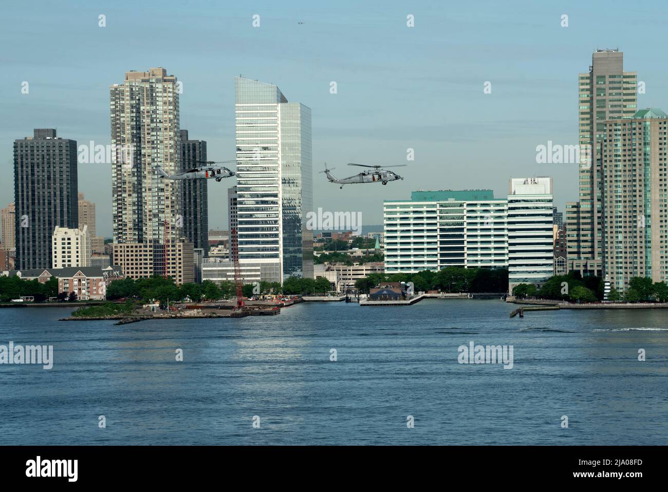 Two helicopters from the US Navy's Helicopter Sea Combat Squadron (HSC) flying over the Hudson River and Jersey City, New Jersey as part of Fleet Week Stock Photo