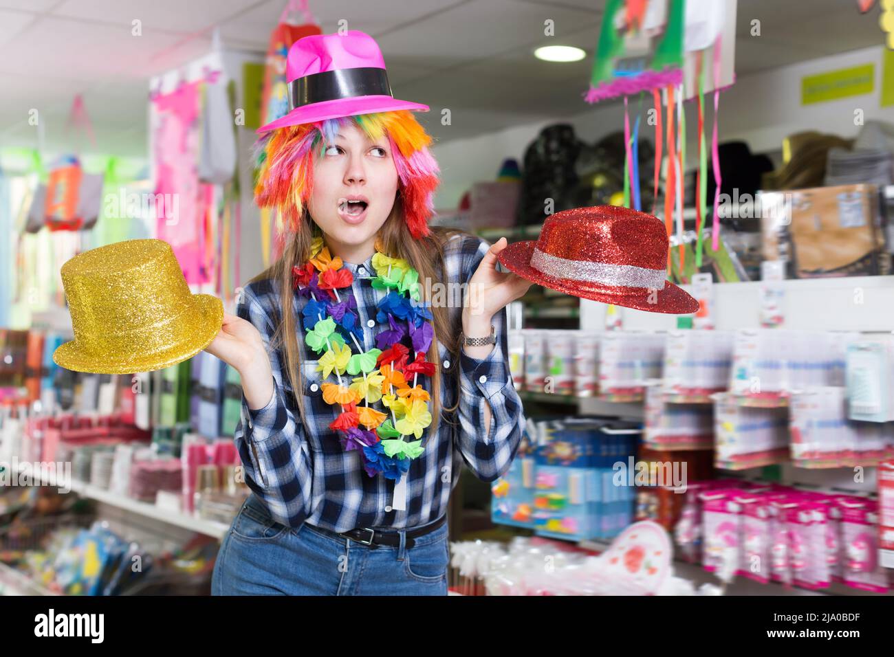 Cheerful woman choosing funny headdresses Stock Photo